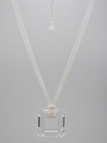 Fine round rolo link sterling silver chain layered and knotted around 30 mm square clear crystal ring pendant.