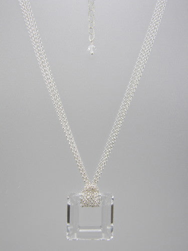 Fine round rolo link sterling silver chain layered and knotted around 30 mm square clear crystal ring pendant. 