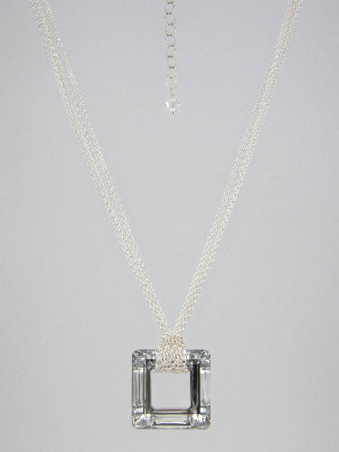 Fine round rolo link sterling silver chain layered and knotted around 30 mm square silver crystal ring pendant.